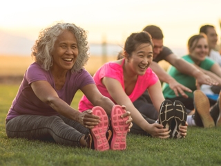 Women and men stretching before a workout. 