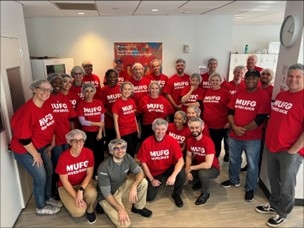 MUFG Employees in red shirts volunteering together